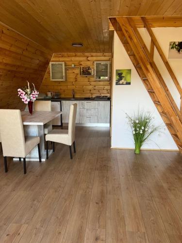 a dining room with a table and chairs at Liniștea Muntilor Cartioasra in Cîrţişoara