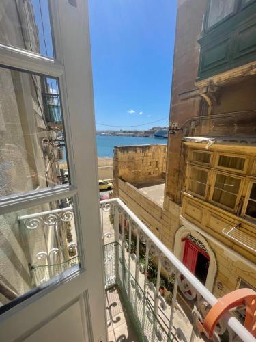 a balcony with a view of the ocean at MoCo, modern comfort in historic city of Senglea in Senglea