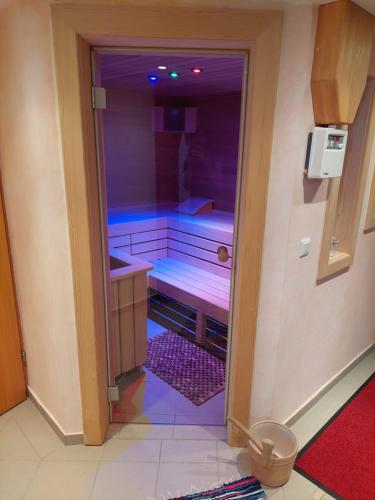 a small bathroom with a shower with purple lighting at Ferienhaus Kristina/Hebalm in Deutschlandsberg