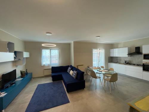 a living room with a blue couch and a table at Appartamento Luigi in Ventimiglia