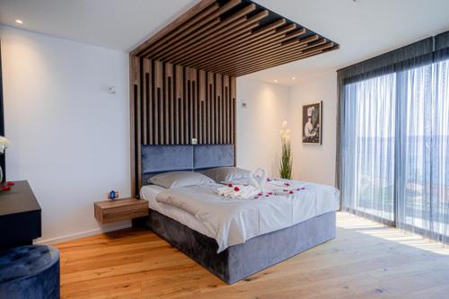 a bedroom with a large bed and a large window at Villas-Kroatien in Trogir