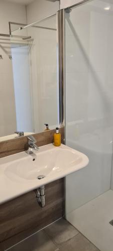 a bathroom with a sink and a mirror at Aparthotel Apartamenty Czarna Góra 227 in Sienna