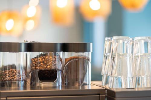 a counter with a coffee maker with coffee beans at Ostsee Apartmenthotel in Graal-Müritz