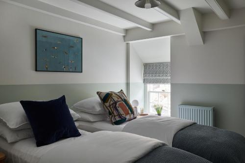 two beds sitting next to each other in a bedroom at Major House- Luxury Pembrokeshire Coastal Getaway in Newport Pembrokeshire