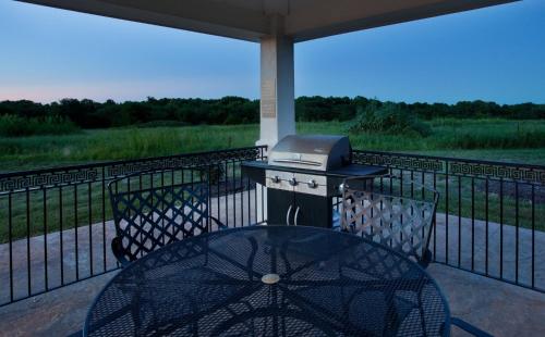 a grill sitting on top of a table on a balcony at Candlewood Suites Olathe by IHG in Olathe