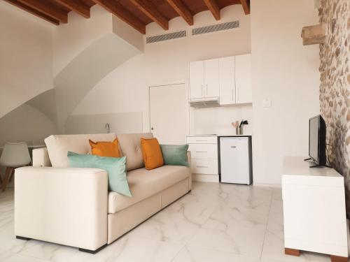 a living room with a couch and a kitchen at Termas Romanas Allon by Seaward Suites in Villajoyosa