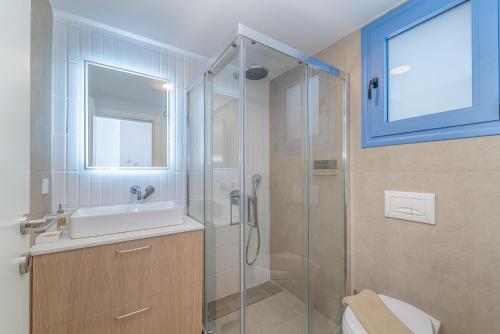 a bathroom with a glass shower and a sink at Greek Beach House B7 Lefkada in Nydri