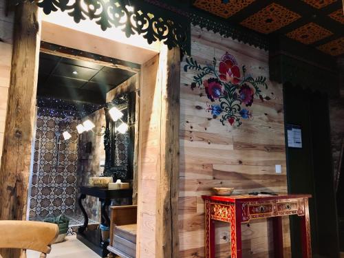 a room with a wooden wall with a table and a mirror at SPA La Casa Blue in Wingles