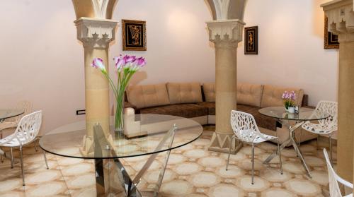 a living room with two tables and a couch at Utopia Hotel Baku in Baku