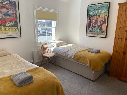 a bedroom with two beds and a window at Number 29, Westgate-on-Sea in Westgate-on-Sea