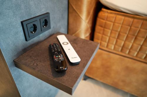 two remote controls sitting on top of a table at Nomad Water Studio in Harderwijk