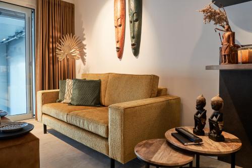a living room with a couch and a table at Nomad Water Studio in Harderwijk