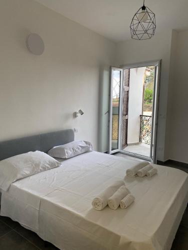 een slaapkamer met een groot wit bed en handdoeken bij Pellegrino Rooms in Vernazza