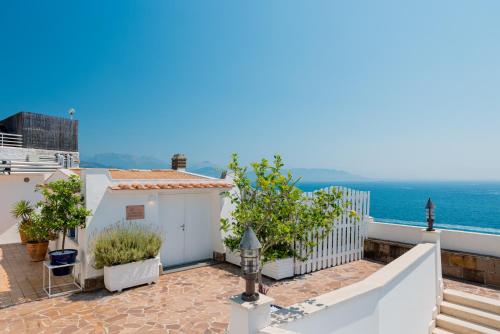 a view of a house with the ocean in the background at La Vecchia Portineria in Cetara