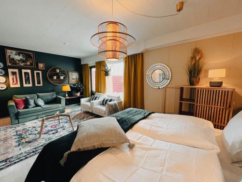 a bedroom with a large bed and a living room at Pieni lomahuoneisto ja ulkoporeallas in Mynämäki