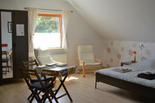 a bedroom with a bed and a table and chairs at B&B Prosterath-Hochwald in Prosterath