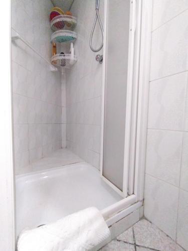 a bathroom with a shower with a towel on the floor at OLD VILLAGE Apartment in Ponte di Legno