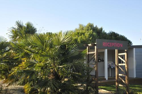a sign in front of a building with a evacuation sign at Camping Le Beaulieu in Puilboreau