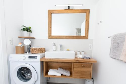 a bathroom with a sink and a washing machine at Ferienwohnungen in der alten Schnapsbrennerei Kolleritsch in Mureck in Mureck