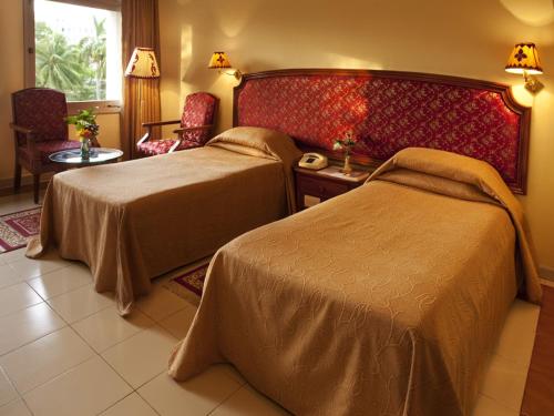 En eller flere senge i et værelse på Hotel Kalinga Ashok