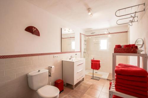 a bathroom with a white toilet and a sink at Can Jaume Guillem in Sant Carles de Peralta