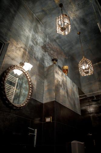 a room with a mirror and chandeliers on the ceiling at Repubblica Di Oz Rooms in Varese