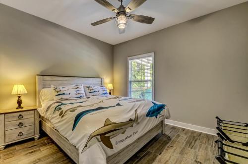 a bedroom with a bed and a ceiling fan at Fisherman's Paradise at Crooked River with Stay Better Vacations! in Elliotts Bluff