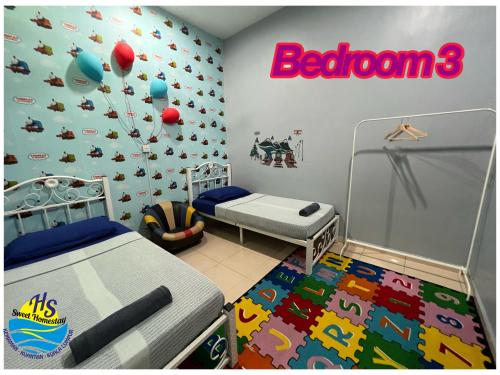 a bedroom with two beds and a sign on the wall at Private Pool HS Sweet Homestay Kemaman in Kemaman