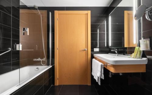 a bathroom with a sink, toilet, and shower at Eurostars Blue Coruña in A Coruña