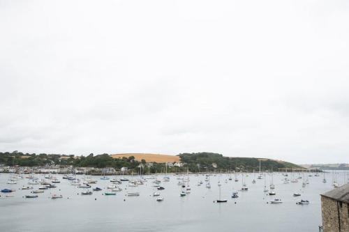 a large group of boats sitting in the water at 4 Bedroom Cottage with panoramic Harbour views in Falmouth