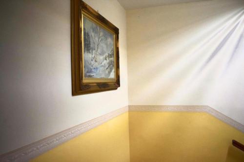 a room with a curtain and a painting on the wall at Hotel Belvedere in Ercolano