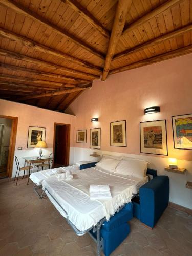 a bedroom with two beds and a wooden ceiling at Il carrubo in Trecastagni