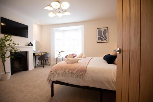 a bedroom with a bed and a television and a fireplace at Sea Renity in Whitby