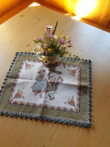 a vase with flowers in it on a table at Thaletalm in Innervillgraten