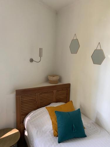 a bedroom with a bed with two pillows on it at Hotel Alexandra - Boutique Hotel in Juan-les-Pins