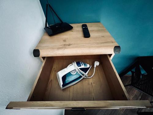 a wooden table with a cell phone on top of it at eM Apartment 17 in Katowice