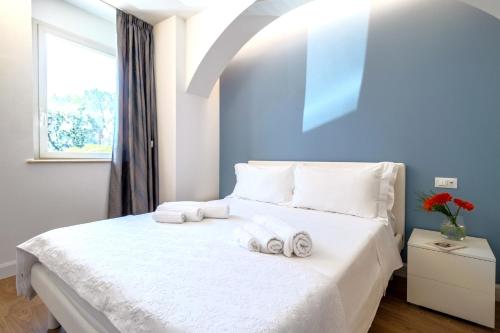 Postel nebo postele na pokoji v ubytování Marinelli Apartments - La Meridiana