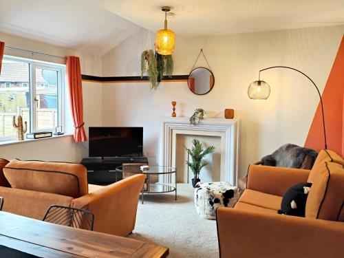 sala de estar con muebles de color naranja y TV en Carvetii - Phoenix House - Near Hospital, max 8 ppl, en Carlisle
