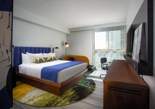 a hotel room with a bed and a television at Hotel Indigo Miami Brickell, an IHG Hotel in Miami
