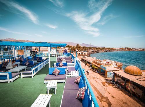 a cruise ship deck with beds and the ocean at Bamboo House Hotel Dahab in Dahab