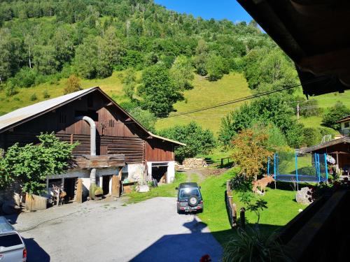 an old car parked in front of a barn at Pension Schlager Taxerhof in Bad Hofgastein