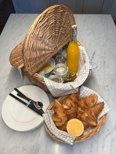 a basket of pastries and a bottle of orange juice at de Bloemgracht in Amsterdam