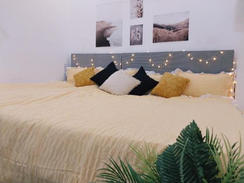 a bedroom with a large bed with lights on it at Triple-T Homestay VTS in Vung Tau