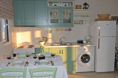 a kitchen with a table with wine glasses on it at Orange apartment in Zarós