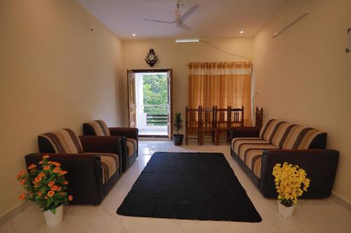 a living room with couches and a table at God's gift in Devikolam