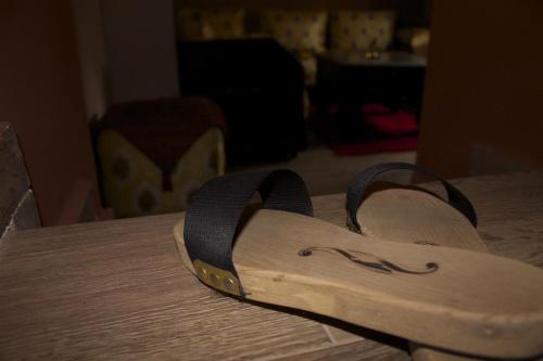 a pair of sandals sitting on top of a table at Collier De La Colombe in Meknès
