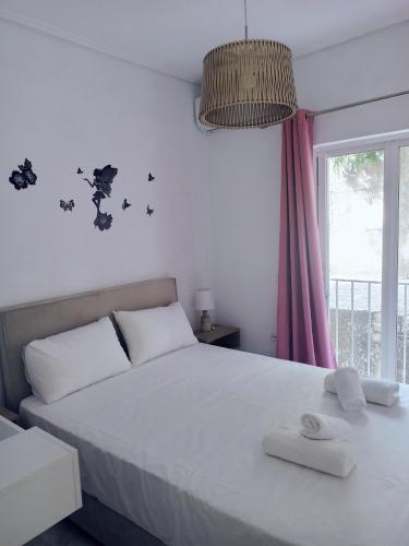 a bedroom with a bed with two towels on it at Levante Breeze in Xirokástellon