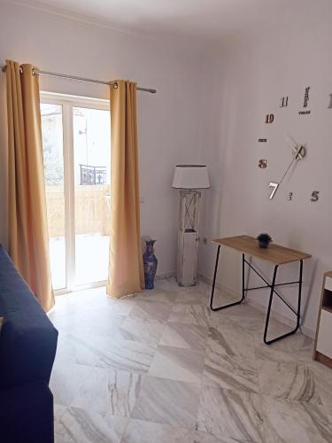 a living room with a table and a window at Levante Breeze in Xirokástellon