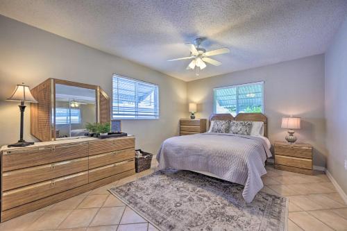 a bedroom with a bed and a ceiling fan at Canalfront New Port Richey Home with Boat Dock! in New Port Richey