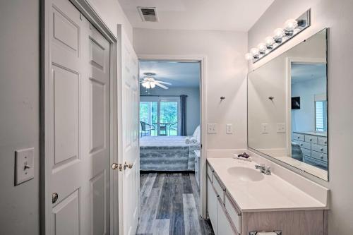a bathroom with a sink and a mirror at Myrtle Beach Condo with Screened Porch and Pool Access in Myrtle Beach